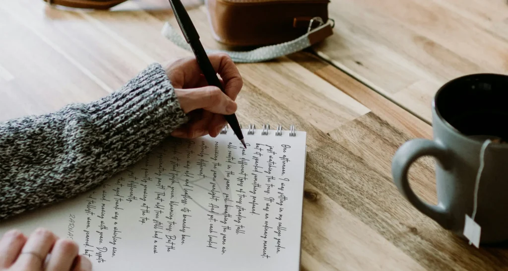 Young woman writing notes in a journal with coffee cup beside her Psychic Reverie blog empowers youth to navigate life’s challenges with expert insights on mental health, wellness, and emerging future trends. Gain proven strategies for personal growth, motivation, academic success, and career development to help you thrive both in work and life. Explore effective study tips designed to boost your confidence and performance.