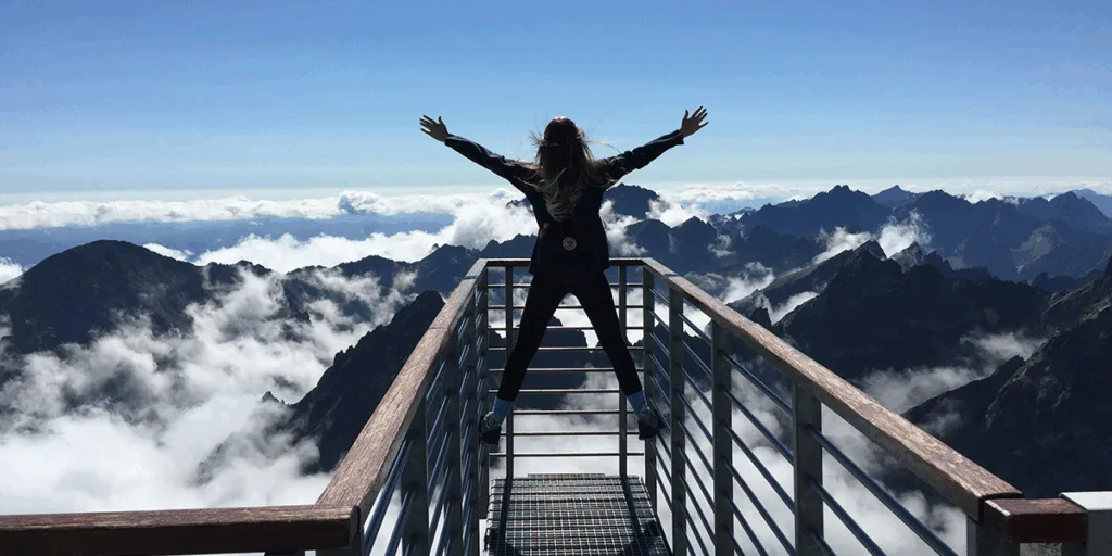 A girl standing on the edge of Bridge on the cold mountains covered with snow. Everything Feels Frozen in Time. Why Am I Not Progressing?