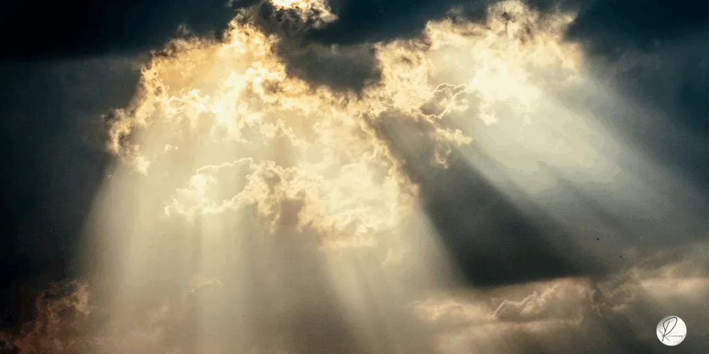 the vast sky full of clouds and the sun rays come from it ike the divine lights