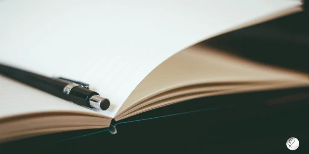 A book And a pen representing A dreamer's journal and the thoughts written in it. the whole point is, when a year is coming to an end, we do the same with our personal affairs.