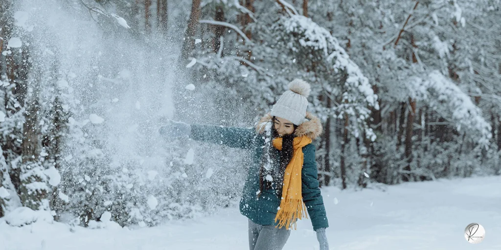 A girl Playing in snow and the snowball representing the joy and accepting the fate of the whole year as well as the experiences gained from the whole year